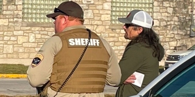 Tim Bliefnick speaks with a deputy as investigators search his home on Wednesday, March 1, 2023. Police left without making any arrests but said they temporarily detained someone during the execution of a search warrant in connection with the shooting death of his estranged wife, Becky Bliefnick.