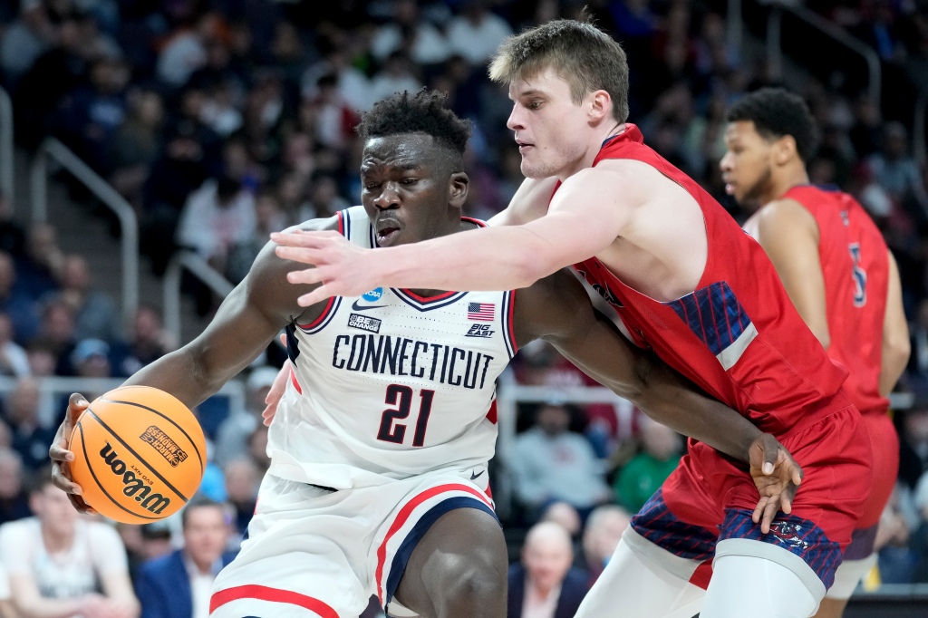UConn's Adama Sanogo (21) drives against Saint Mary's Mitchell Saxen, right, in the second half of a second-round college basketball game in the NCAA Tournament, Sunday, March 19, 2023, in Albany, N.Y.