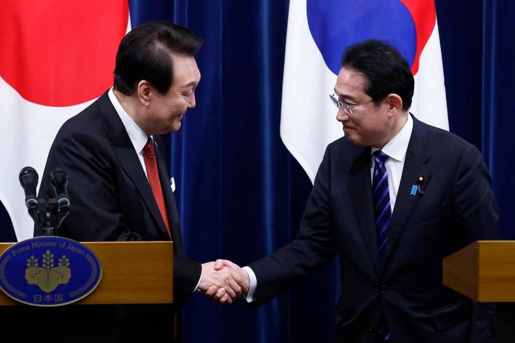 South Korean President Yoon Suk Yeol, left, and Japanese Prime Minister Fumio Kishida, right, shake hands following a joint news conference at the prime minister's official residence in Tokyo, Japan, Thursday, March 16, 2023.