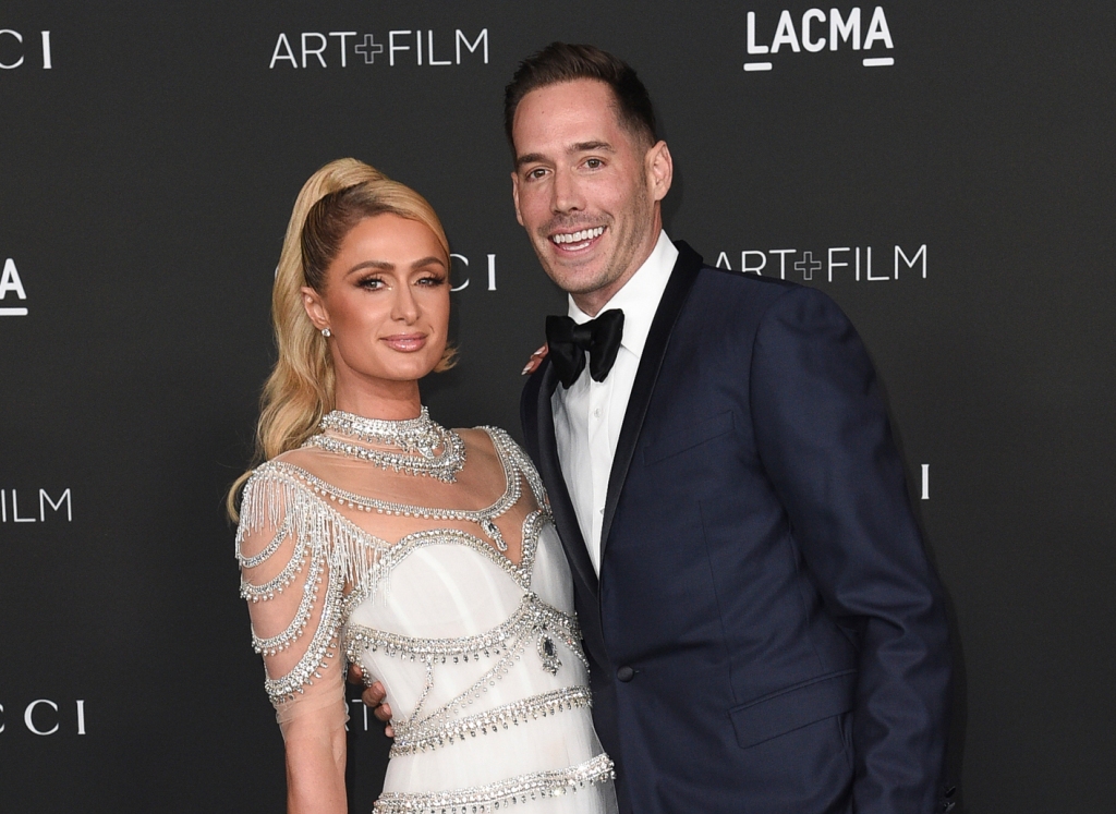 Paris Hilton and her husband, venture capitalist Carter Reum pose on the red carpet.