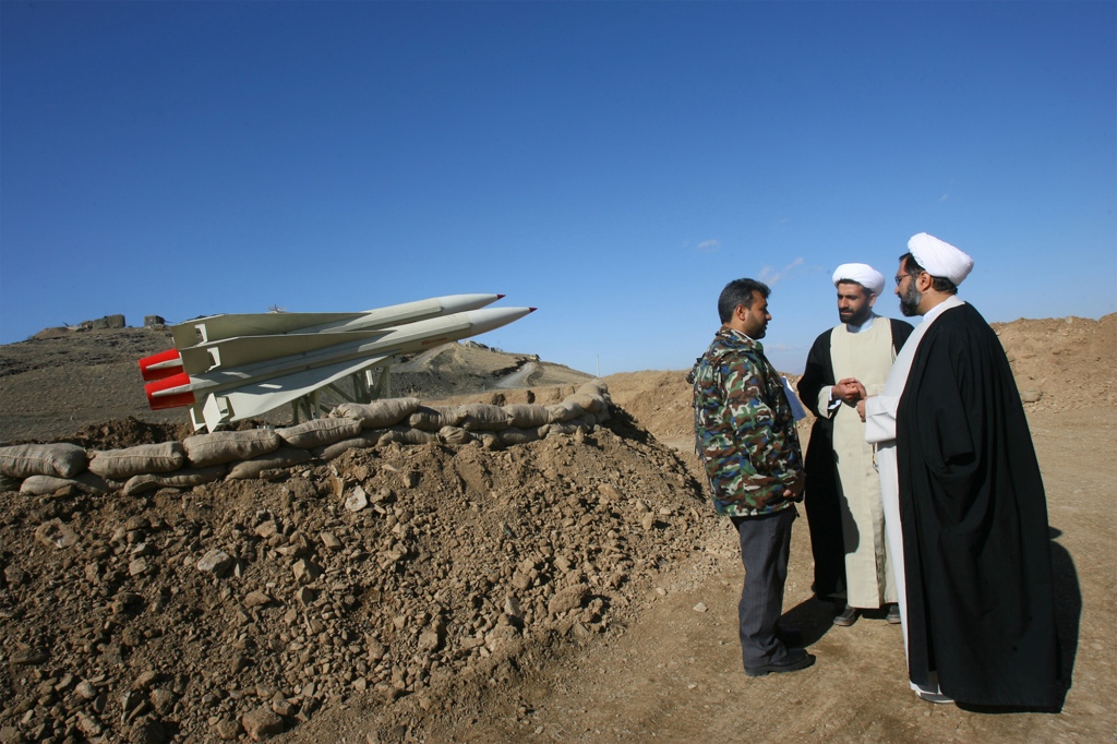 Iranian clergymen stand next to air defence missiles during military exercises held near the city of Malayer, 300 kms southwest of the capital Tehran, on November 23, 2009.