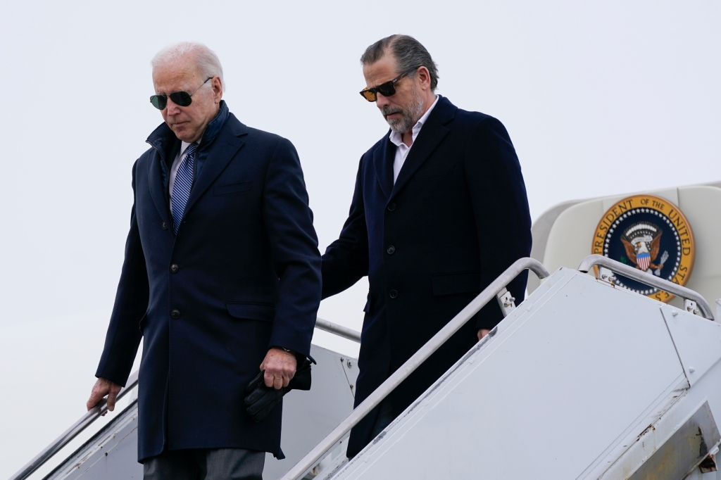 President Biden and Hunter Biden walk down stairs out of presidential plane. 