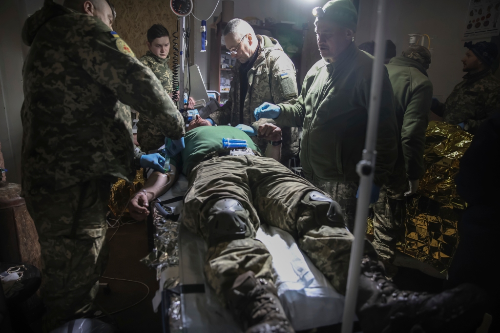 Medics give the first aid to a wounded Ukrainian soldier near Bakhmut.