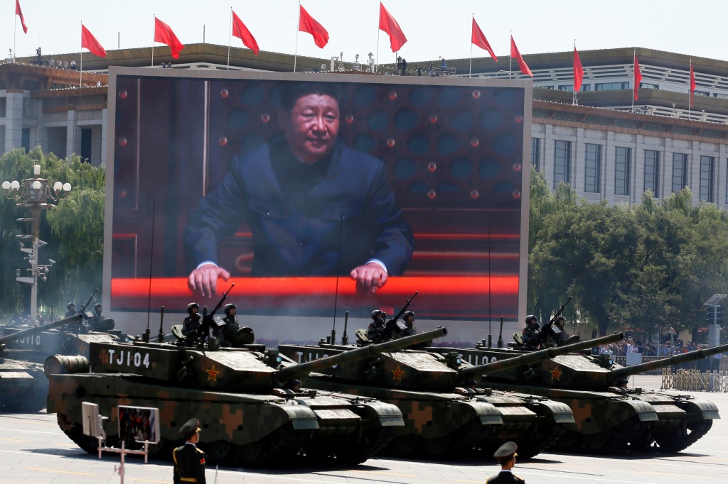 Military tanks and Xi Jingping on a monitor