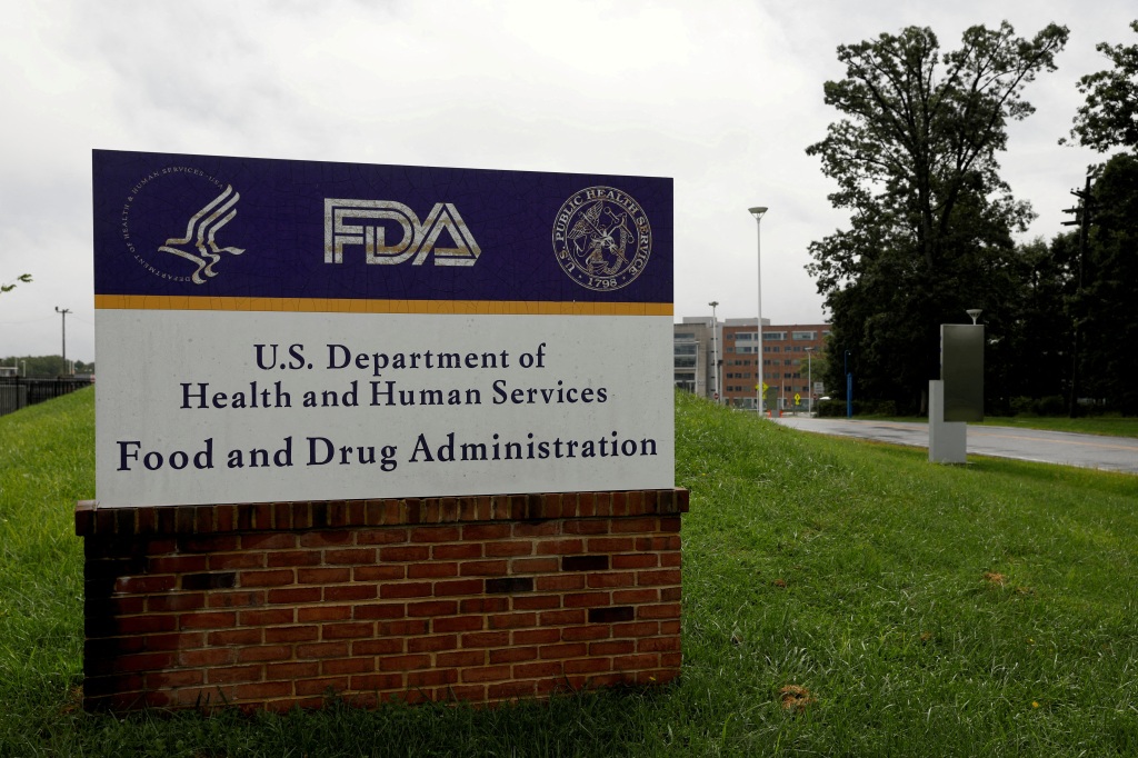 The U.S. Food and Drug Administration building behind FDA logos at a bus stop on the agency's campus in Silver Spring, Md., on Aug. 2, 2018. 