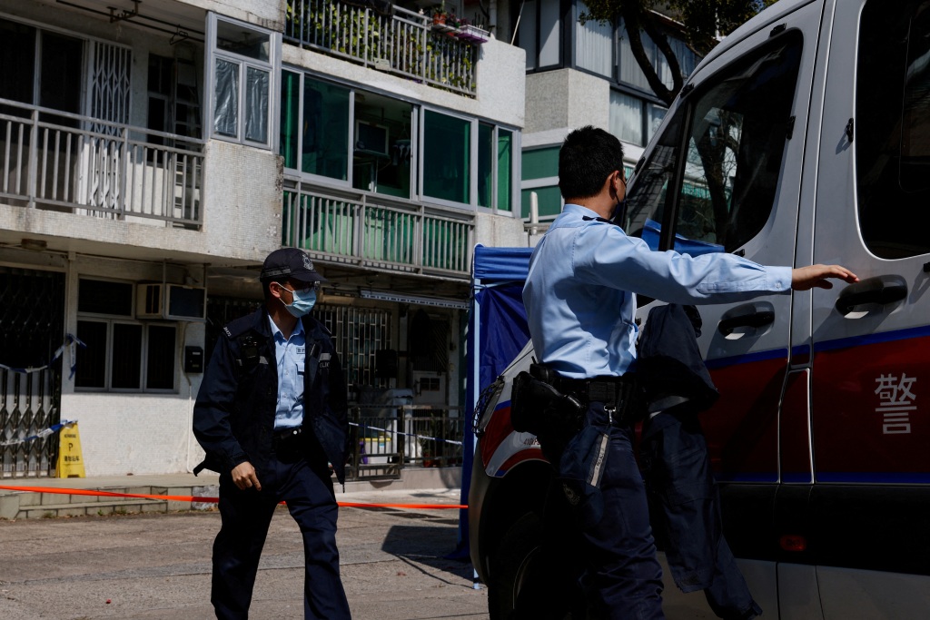 Hong Kong police on Monday patrol outside a village house where part of Abby Choi's body was found.