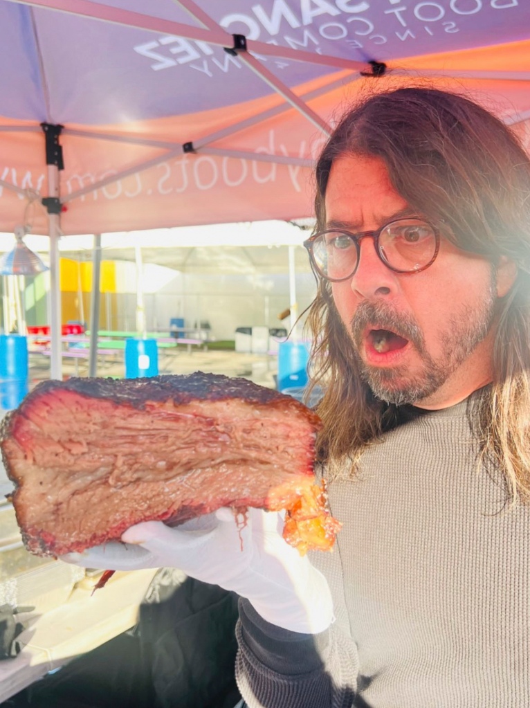 Dave Grohl holding up meat.