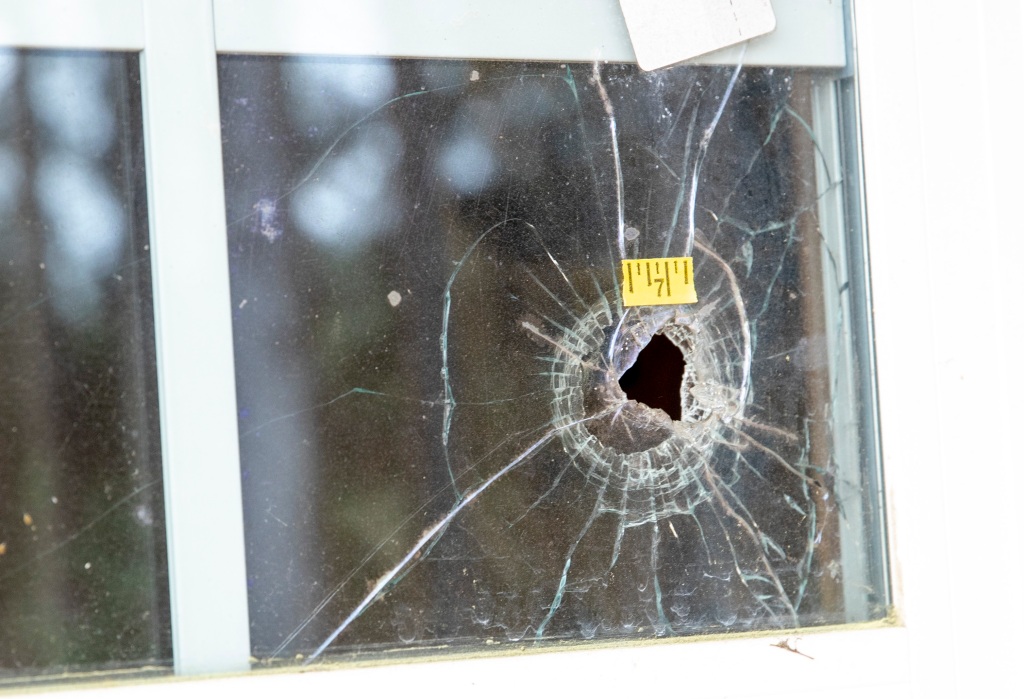 A bullet hole in a glass window.