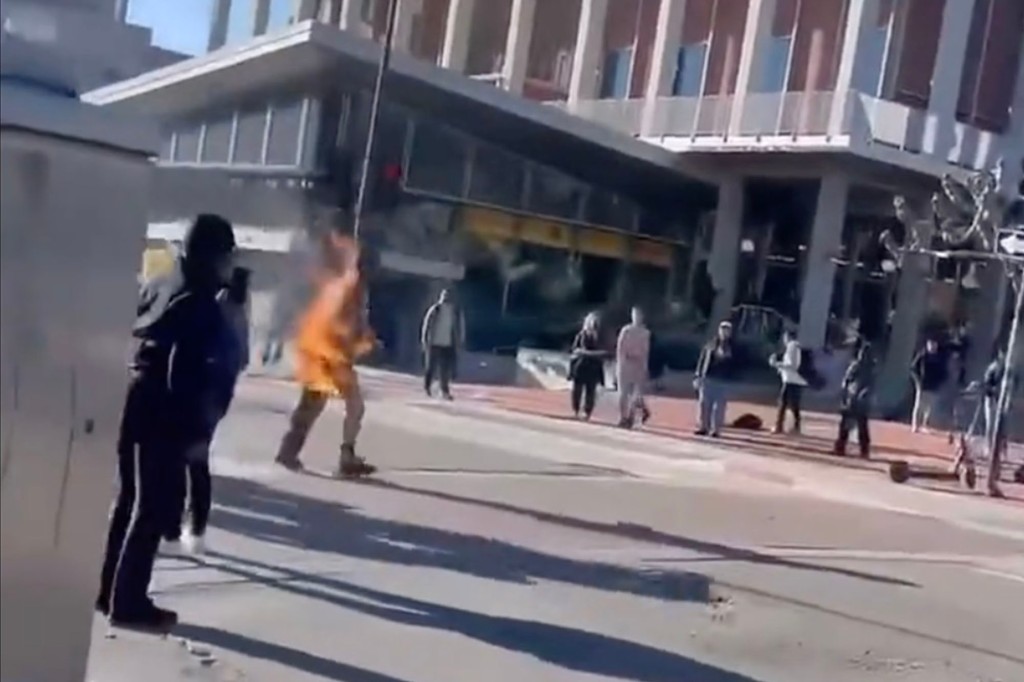 A man on fire walks through UC Berkeley campus. 