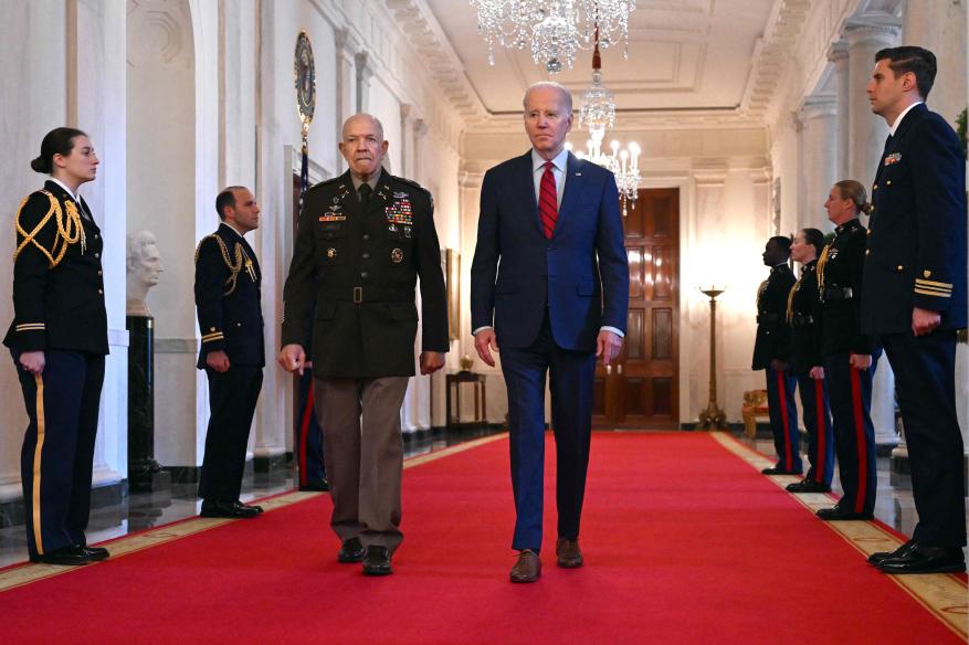 President Joe Biden and retired Col. Paris Davis walking down the hall.