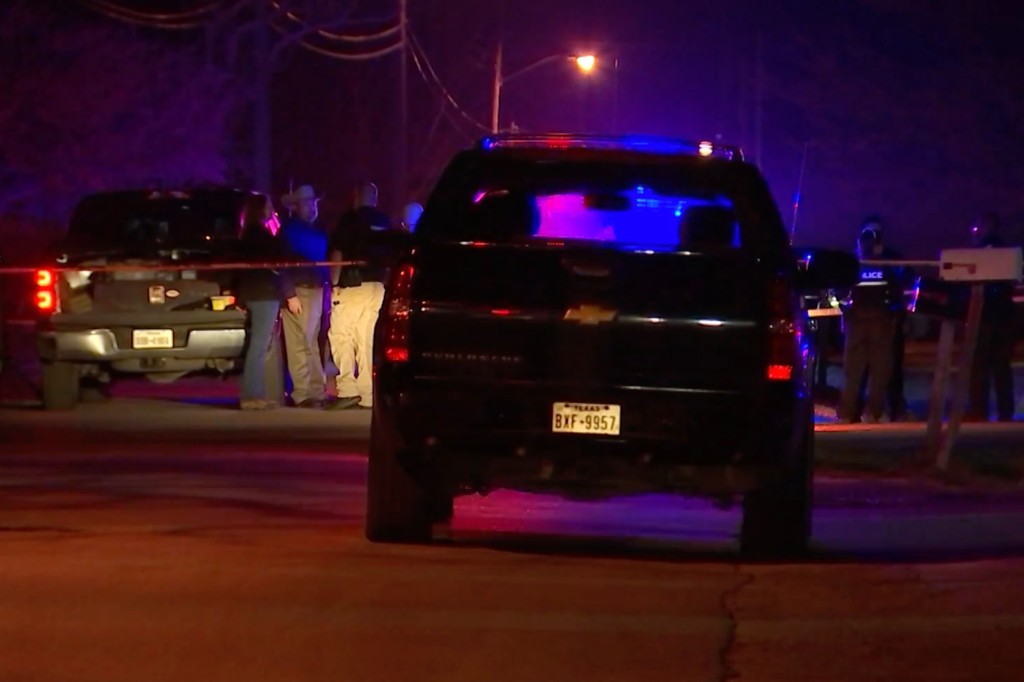 police are pictured outside the home where three children were killed.