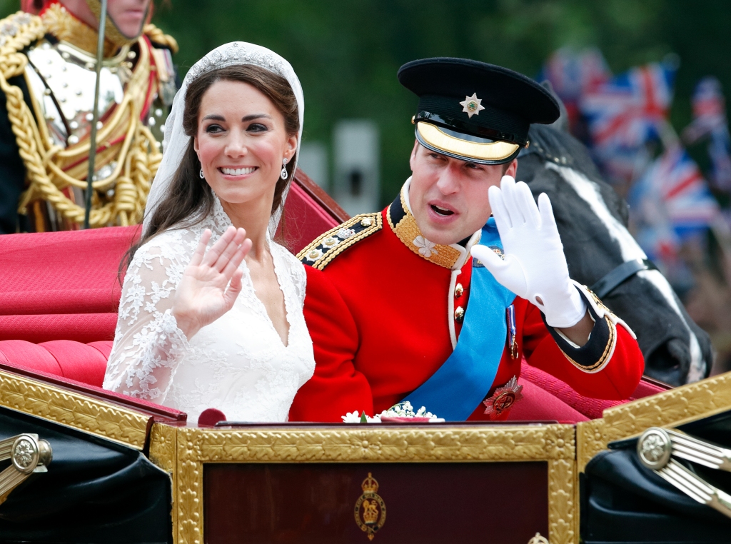 Catherine, Duchess of Cambridge and Prince William, Duke of Cambridge travel down The Mall, en route to Buckingham Palace, following their wedding ceremony at Westminster Abbey on April 29, 2011 in London, England.