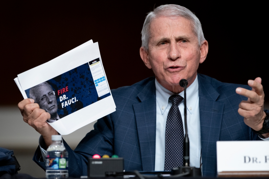 Dr. Anthony Fauci holds up a printout of a campaign donation webpage on January 11, 2022.