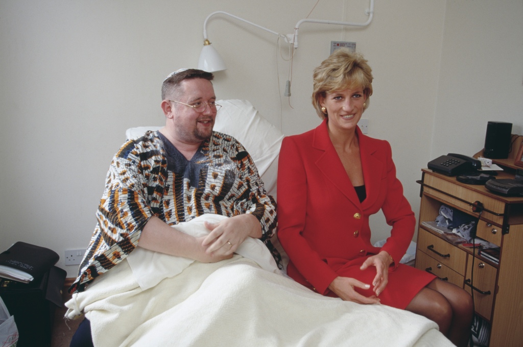 Princess Diana sits with a patient during a visit to London Lighthouse, a center for people affected by HIV and AIDS, in London in October 1996. 