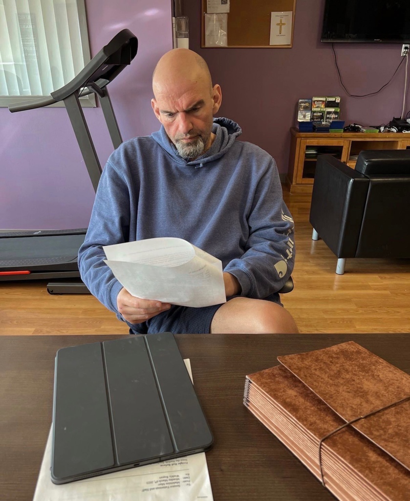 Sen. John Fetterman looks over some papers in the hospital.