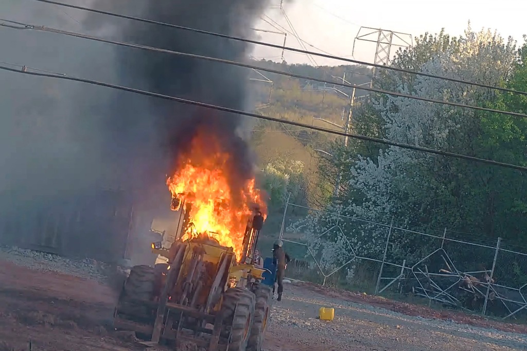 Construction equipment on fire during protest