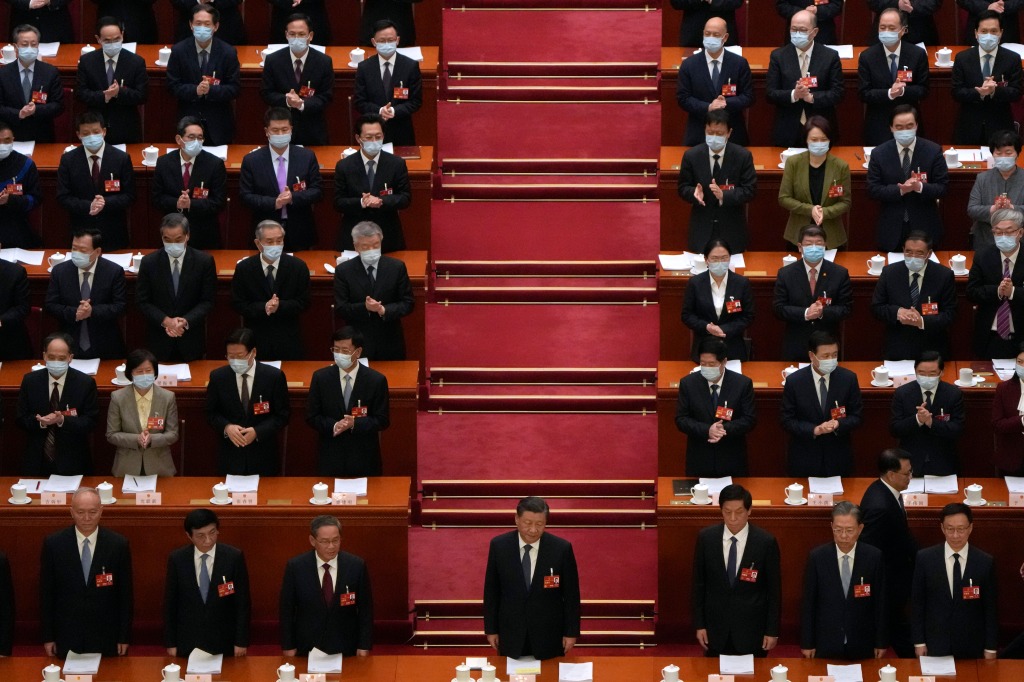 Chinese President Xi Jinping, center, and other leaders stand during a session of China's National People's Congress (NPC) at the Great Hall of the People in Beijing, Tuesday, March 7, 2023. 