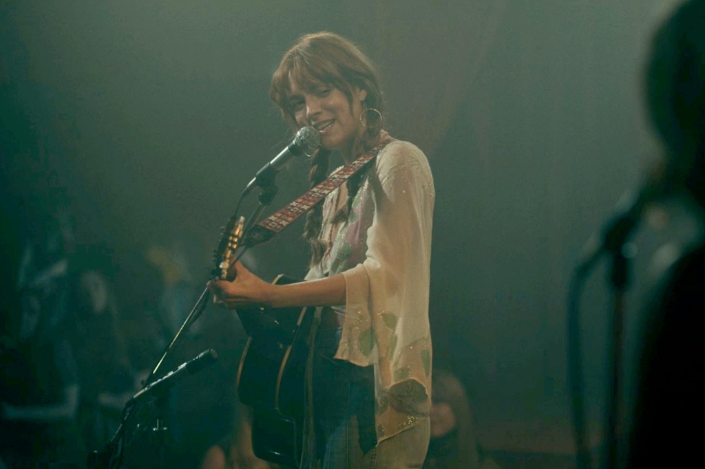 Screengrabs from Amazon Prime's Daisy Jones & the Six, in which Riley Keough's character wears a guitar strap matching one worn by Elvis Presley during his '68 comeback shows
