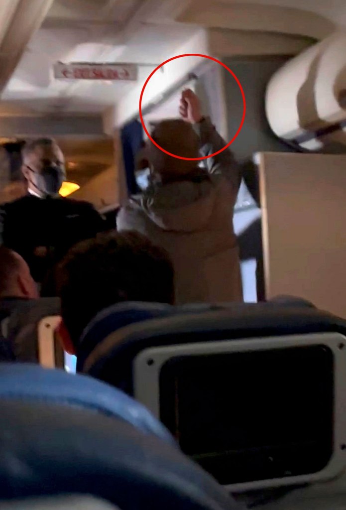 The man is accused of trying to stab a flight attendant with a broken spoon.