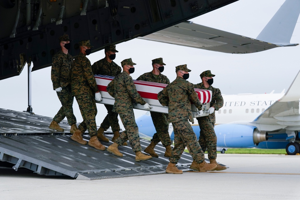 A Marine Corps carry team moves a transfer case containing the remains of Marine Corps Lance Cpl. David Espinoza, 20, of Rio Bravo, Texas on Sunday, Aug. 29, 2021, at Dover Air Force Base, Del. According to the Department of Defense, Espinoza died in an attack at Afghanistan's Kabul airport, along with 12 other U.S. service members supporting Operation Freedom's Sentinel. (AP Photo/Manuel Balce Ceneta)