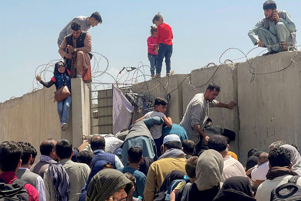 Afghans crowd outside Hamid Karzai International Airport in August 2021.