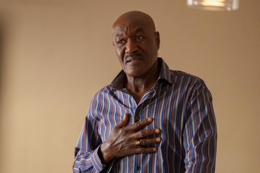 Delroy Lindo stands with his hand over his heart. 