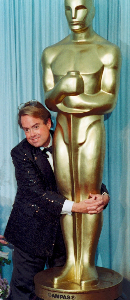 Allan Carr with an Oscars statutette