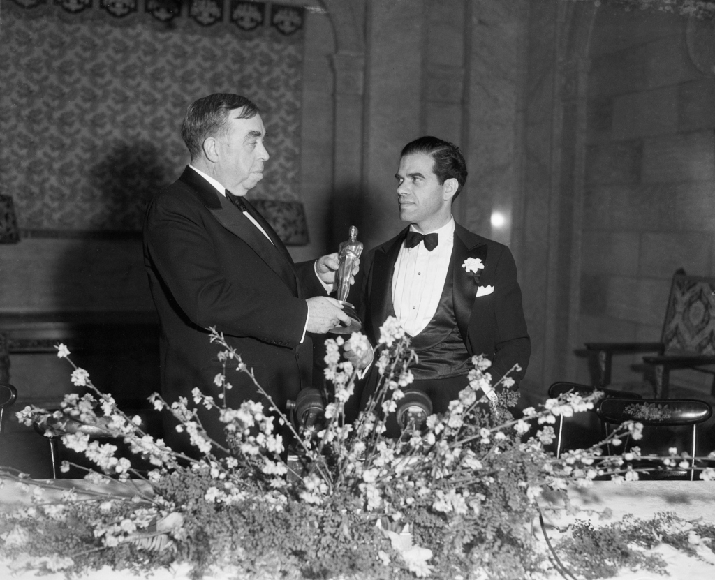 Humorist Irvin Cobb presents an Oscar to director Frank Capra for "It Happened One Night," in 1935.