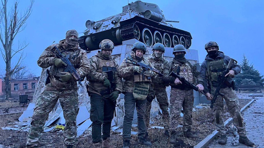 Yevgeny Prigozhin (C) with fighters of the Wagner Group.