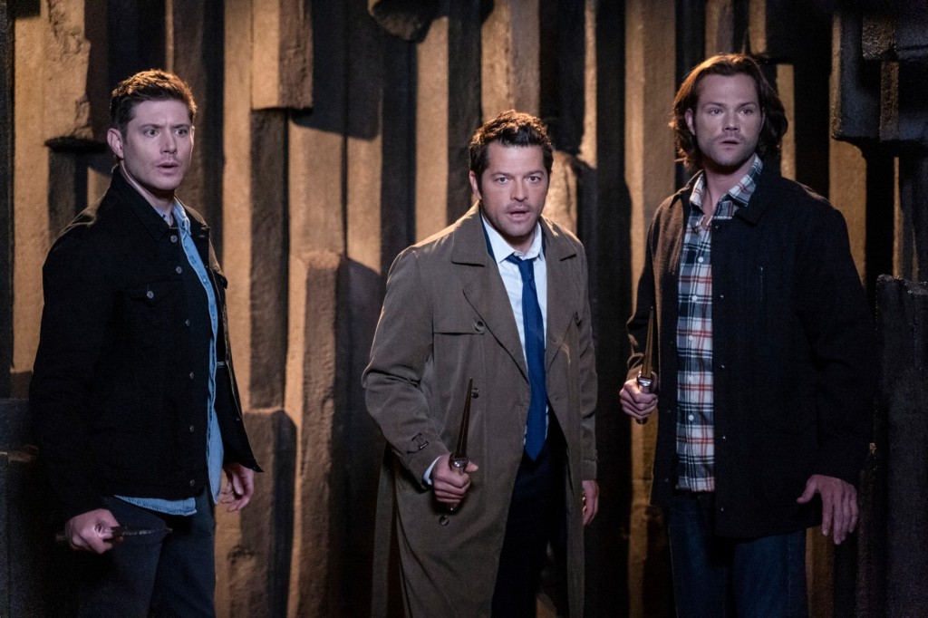 Misha Collins as Castiel in "Supernatural," next to Dean (Jensen Ackles) and Sam Winchester (Jared Padalecki). They all stand in a line, facing an unseen threat. 
