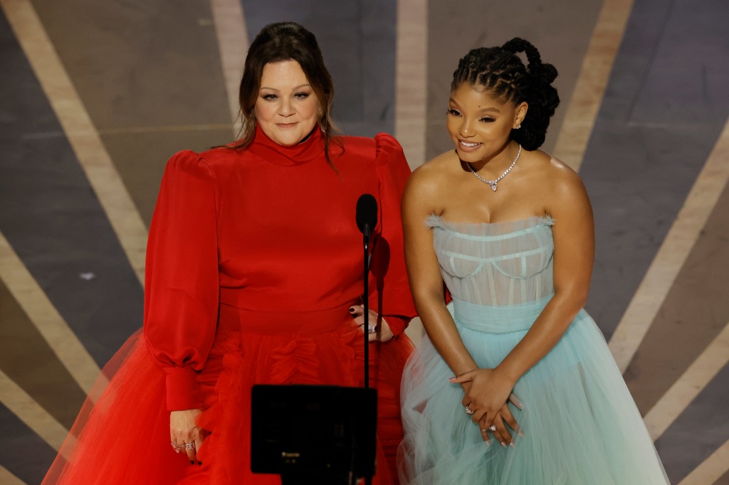 Melissa McCarthy and Halle Bailey at the Oscars onstage in dresses. 