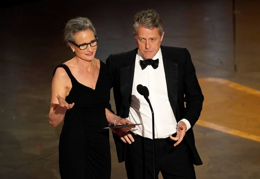 Andie MacDowell, left, and Hugh Grant present the award for best production design at the Oscars on Sunday, March 12, 2023