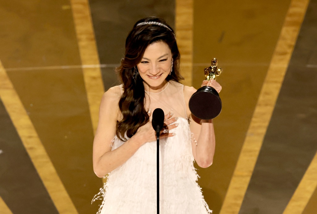 Michelle Yeoh holding an Oscar. 