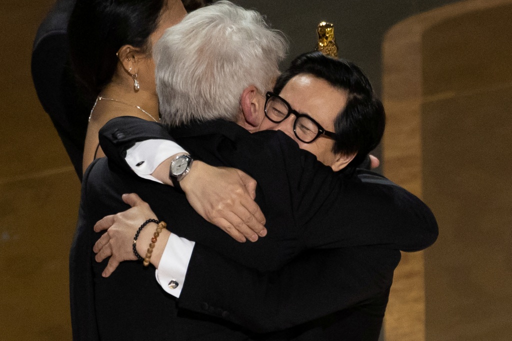 Best Supporting Actor Ke Huy Quan hugs Harrison Ford after "Everything Everywhere All at Once" won the Oscar for Best Picture.