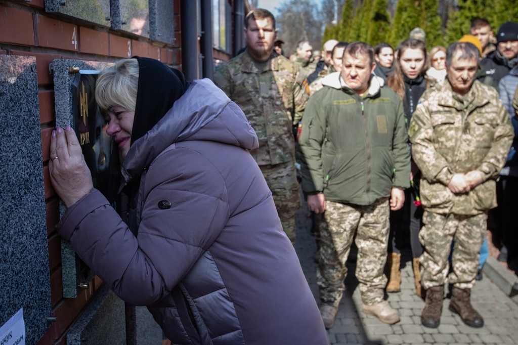 A woman mourns Ukraine's war dead.