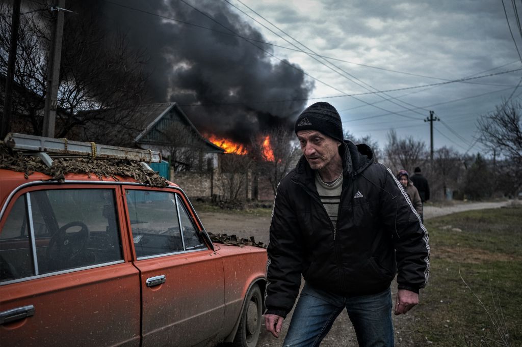 A man flees Russian airstrikes in Ukraine