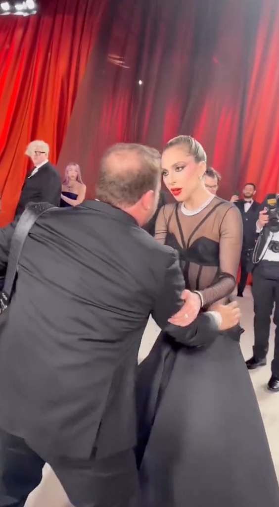 The photographer, who has yet to be identified, then pats the "Born This Way" singer's back and hips two times seemingly earning him a glare from Gaga. 