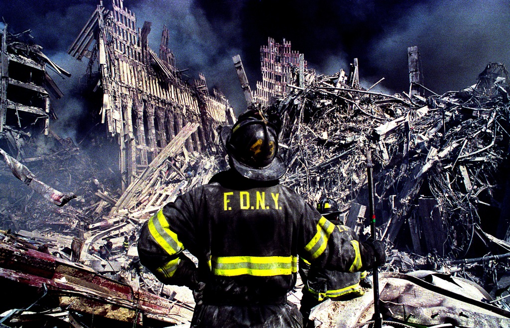 A firefighter looking at the wreckage after 9/11 attacks
