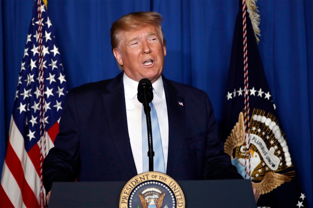 Former President Donald Trump is pictured at a podium.