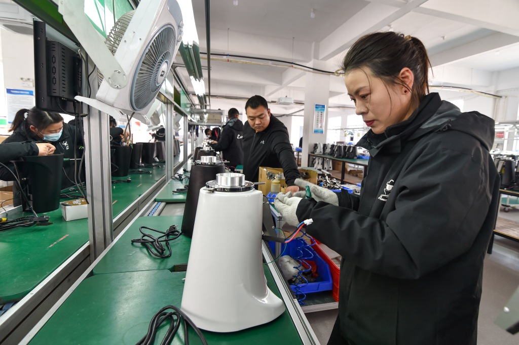A worker assembles a bean grinder for export to Europe, Japan and South Korea at a factory in Suqian, East China's Jiangsu province, Feb 28, 2023.