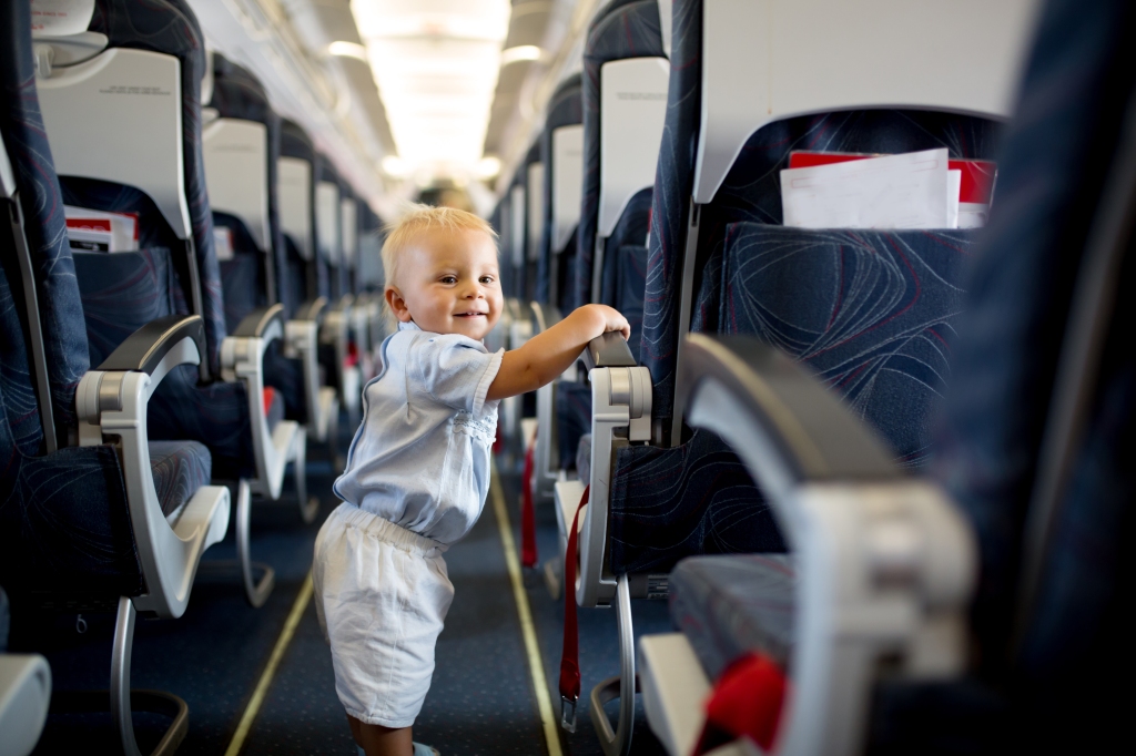 Child in plane aisle.