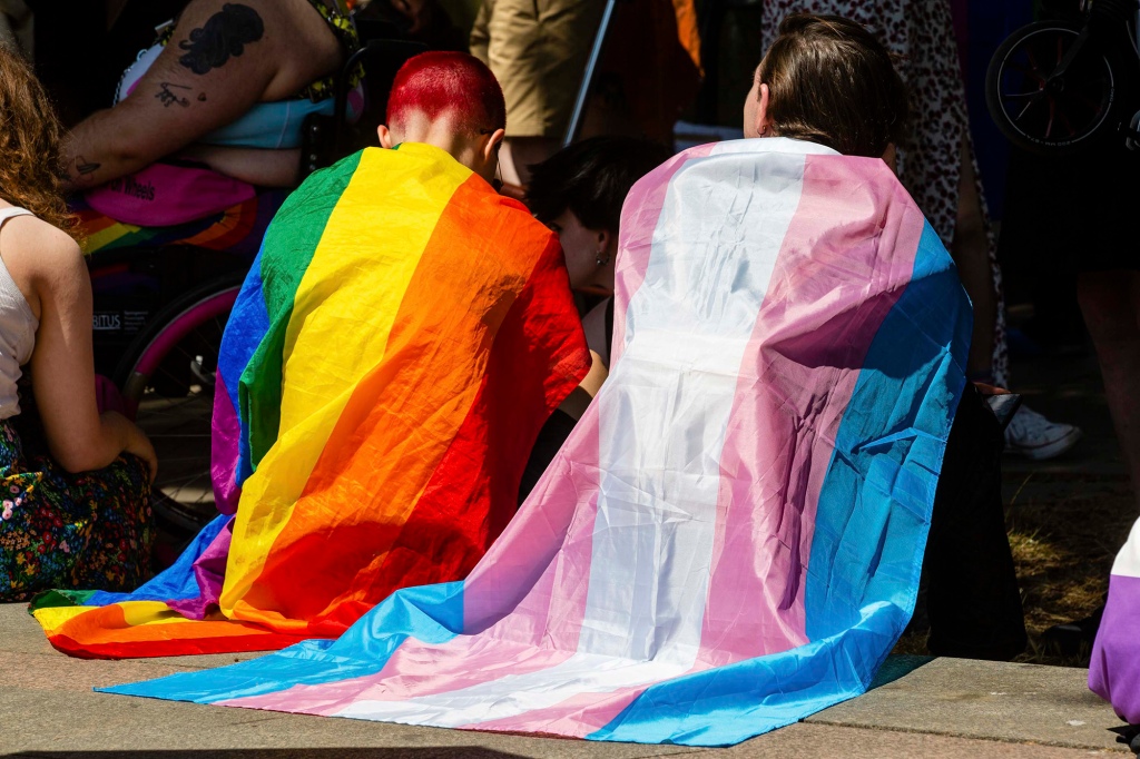 Protesters draped in Rainbow Pride and Transgender flags in London