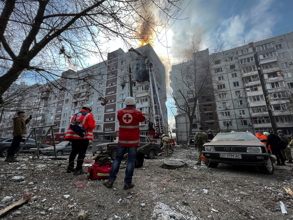 Paramedics and rescuers work at a site of a residential building damaged by a Russian missile strike, amid Russia's attack on Ukraine, in Zaporizhzhia, Ukraine.