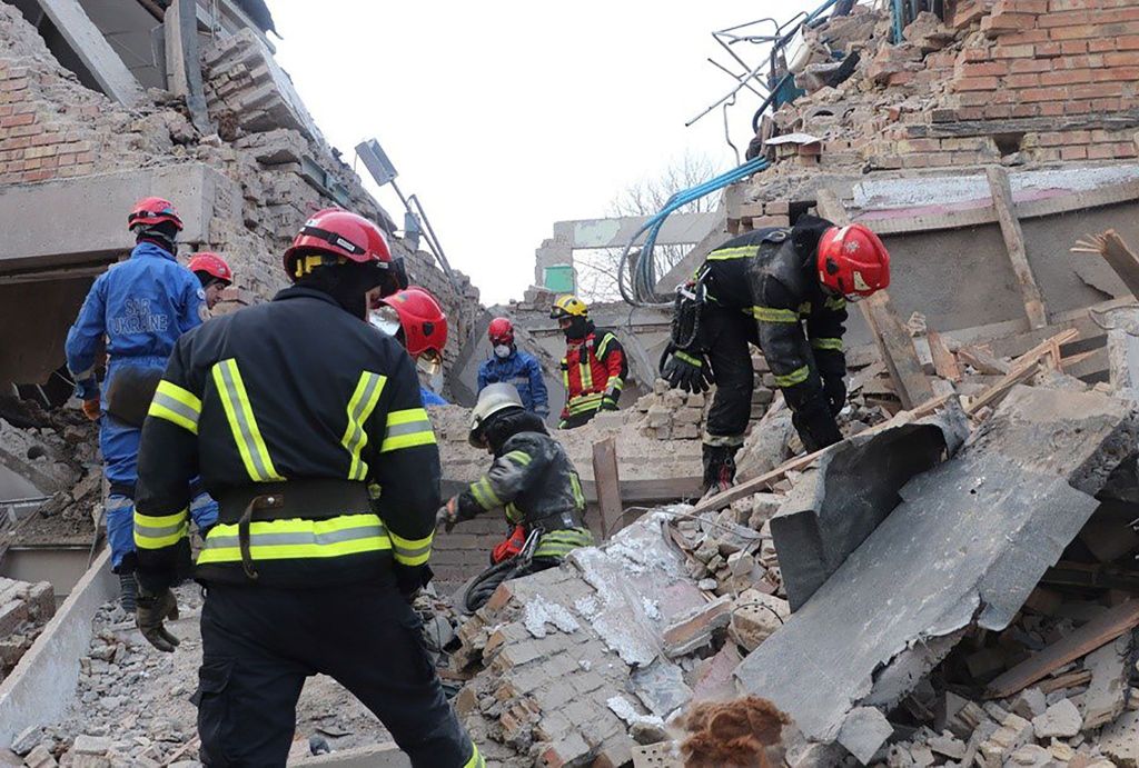 A handout photo released by the press service of the State Emergency Service (SES) of Ukraine on 22 March 2023 shows rescuers working at the site of a building damaged by drone strikes in the town of Rzhyshchiv, Kyiv region, Ukraine, amid Russia's invasion.