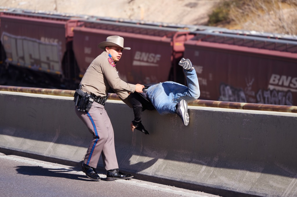 A group of apparent Texas migrants led authorities on a pursuit onto an El Paso overpass, where one man fell, March 22, 2023.