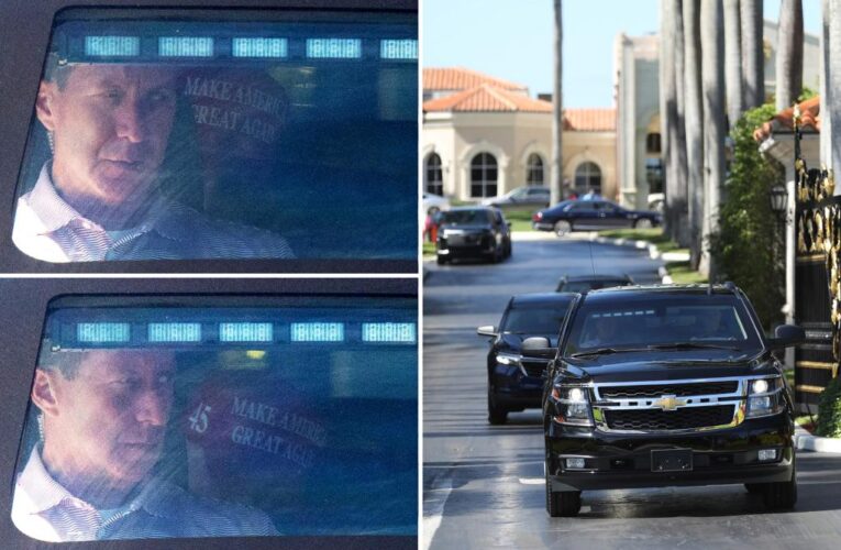 Trump ducks photographers as he leaves Palm Beach golf course