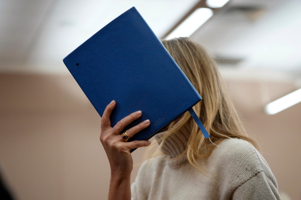 Paltrow shields her face with a blue notebook as she exits a courtroom, Tuesday.