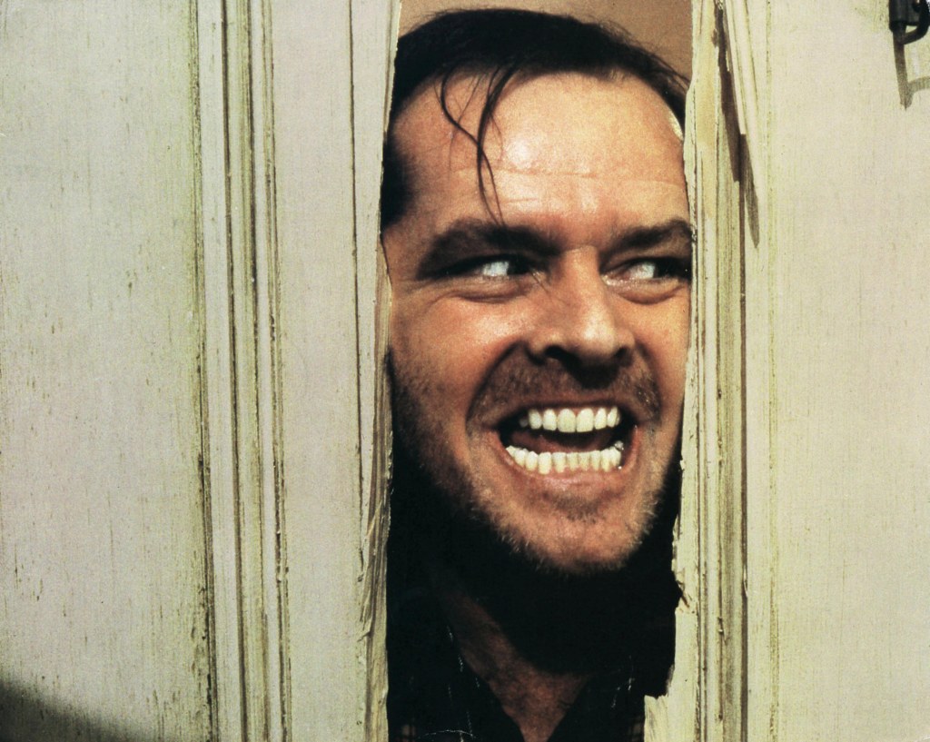 Key scene of Jack Nicholson breaking through a door in "The Shining."