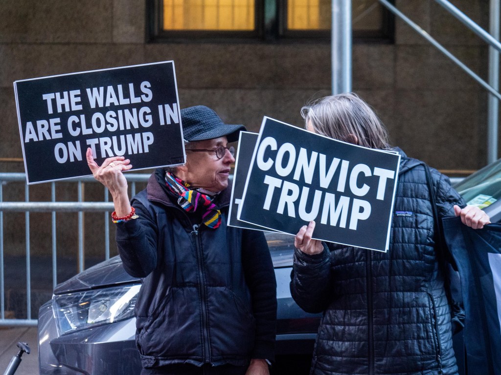 Protesters in NYC holding signs saying: "Convict Trump."