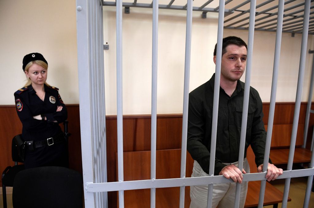 US ex-marine Trevor Reed, charged with attacking police, stands inside a defendants' cage during a court hearing in Moscow on March 11, 2020.